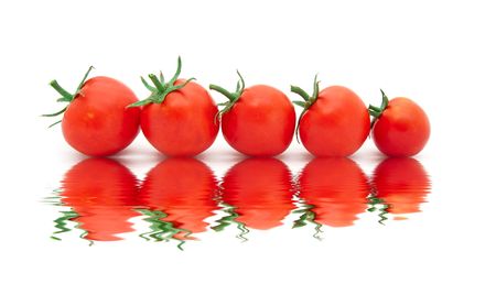  beautiful ripe tomatoes with reflexion in waterの写真素材