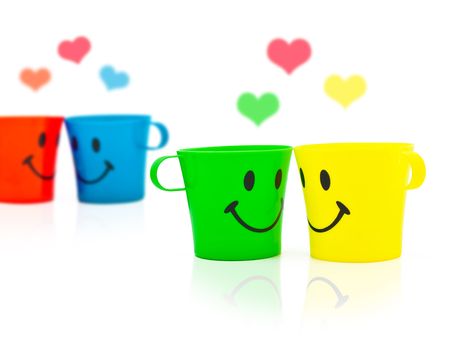 Multi-coloured bright cups with drawing in a kind of smileの写真素材
