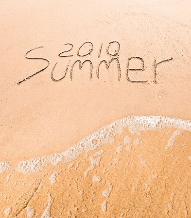 Inscription on wet sand "Summer 2010"の写真素材