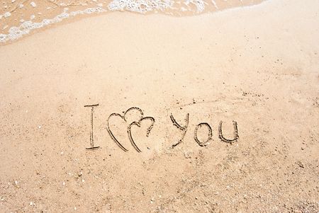 inscription on sand I love you and two connected heartsの写真素材