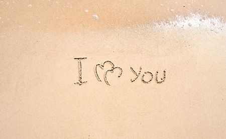 inscription on sand I love you and two connected heartsの写真素材