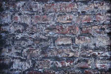 Old grey brick wall - background in grunge styleの写真素材