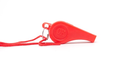 red whistle with a rope on a white backgroundの写真素材