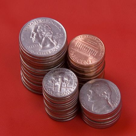 Stacks of coins against a red background