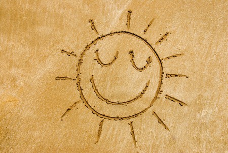 A smiling sun on a beachの写真素材