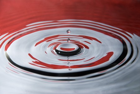 A water droplet against the Indonesian flag colorsの写真素材