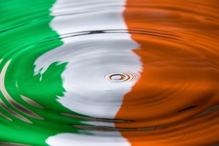 A water droplet against an Irish flag colorsの写真素材