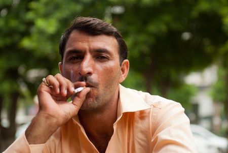 NEW DELHI, INDIA - JULY 22, 2011: An unidentified man smokes a cigarette.のeditorial素材