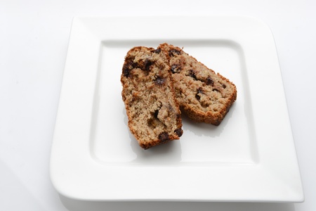 Slices of delicious banana bread on a white plateの写真素材