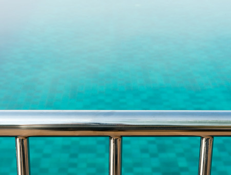 Overlook the swimming pool across a railingの写真素材