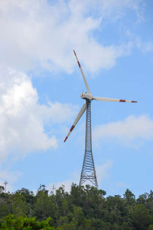 Wind power turbines on towers installed on hills for electricity generation