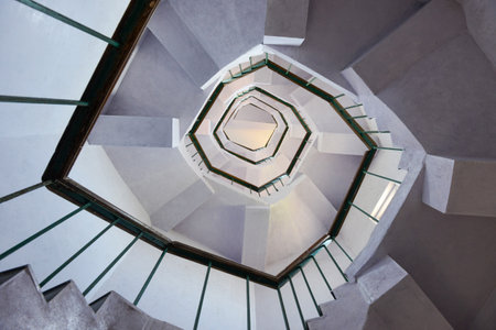 An upward view of a staircase or stairwell with a railingの写真素材
