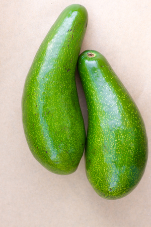 Pair of raw avocados lay on gray background. Yin yang harmony concept