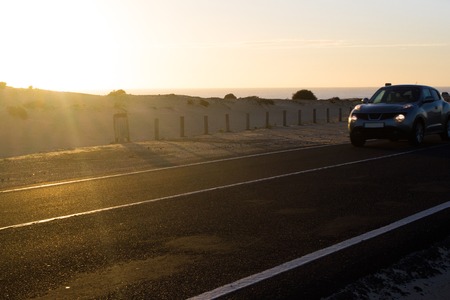 Coast asphalt road. Sunrise on asphalt coat, macro photo of road. Beach way. Highway in Spain.の写真素材