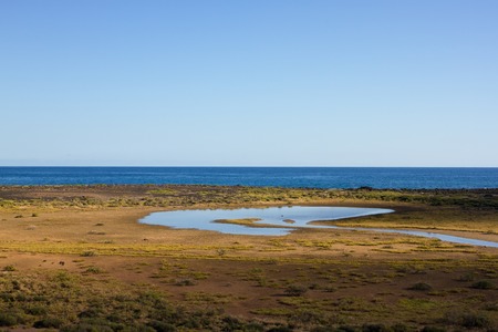 Panoramic ocean view. Volcano, black rocks. Lake.の写真素材