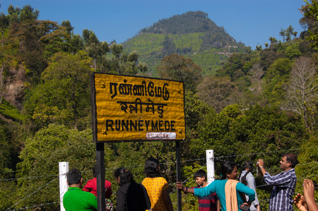 OOTY, TAMIL NADU, INDIA, 20 March 2015 : Nilgiri. Railroad sign Runneymede written in Tamil official language of Tamilnadu , Hindi and English on a platform of the railway stationのeditorial素材