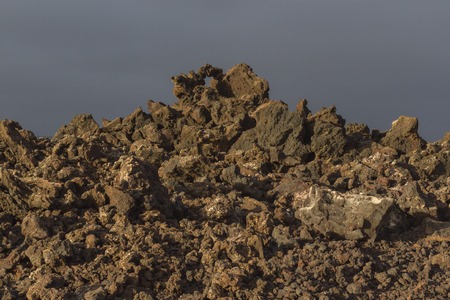 Volcanic rock from lava flow macro. Lava field in Timanfaya National Park in Lanzarote, Canary Islands, Spain.の写真素材
