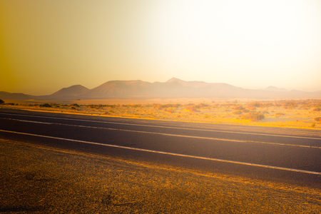 sunset with dramatic clouds over asphalt road. Desert landcape and view. Mountainの写真素材