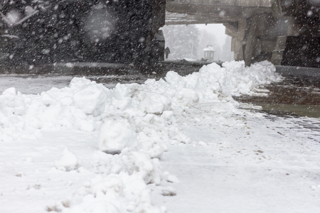 Sweep snow from road in winter. Part of winter frost sidewalk. Cold city streetの写真素材