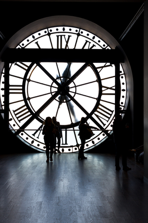 Clock inside tower. Museum Orsay, clock inside with silhouettes of visitorsの写真素材