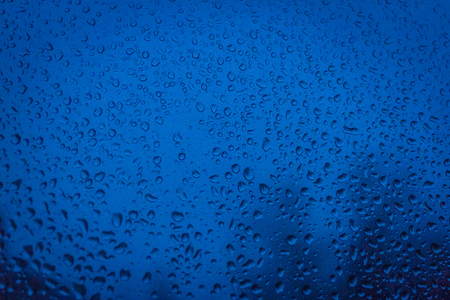 Texture drops and glass. Blue background, nightの写真素材