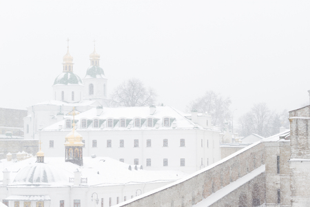 View of Kiev Pechersk Lavra Orthodox Monastery in winter snow storm, Ukraineの写真素材