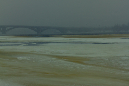 View of the Metro bridge and Dnieper river in dense fog, big snow storm, misty landscape, Kyiv the capital of Ukraine, Eastern Europeの写真素材