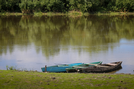 Pair of traditional wood boat on the river boat Desna in Ukraineの写真素材