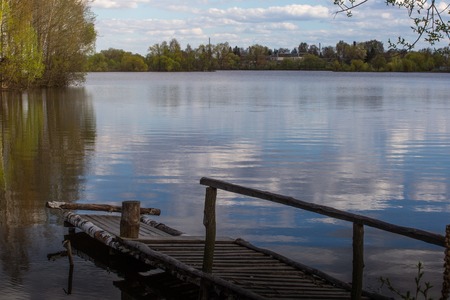 Over flooded with reed in river in spring. Wood bridge. Europeの写真素材