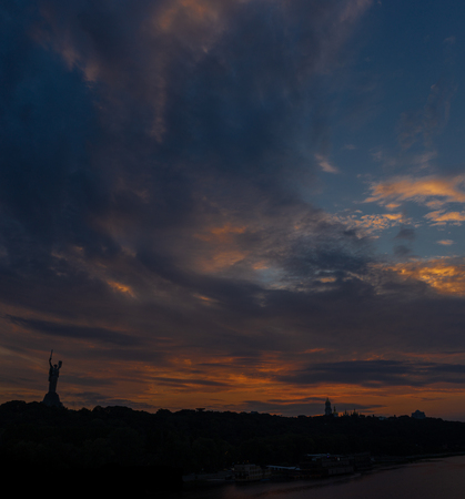 Lavra bell tower silhouette and Motherland Monument against great red sunset and sky in summertime in Ukkraineの写真素材