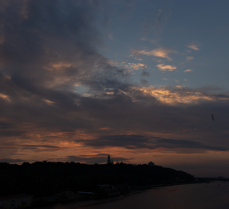 Lavra bell tower silhouette and Motherland Monument against great red sunset and sky in summertime in Ukkraineの写真素材