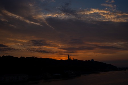Lavra bell tower silhouette and Motherland Monument against great red sunset and sky in summertime in Ukkraineの写真素材