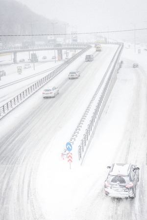 Snow storm on the roads in December in Kiev, Ukraine. Snowy and nothing visibility on the roads