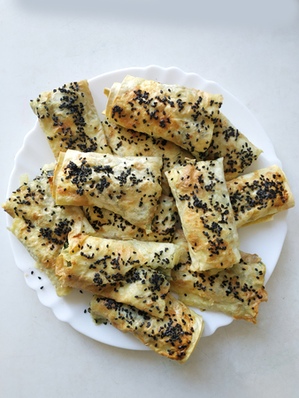 Cutted lavash pieces with vegetables. Burek with spinach and cheese and black cumin. Yufkaの写真素材