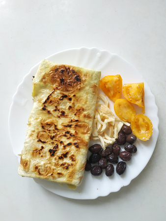 Cutted lavash pieces with vegetables. Burek with spinach and cheese and black cumin. Yufkaの写真素材