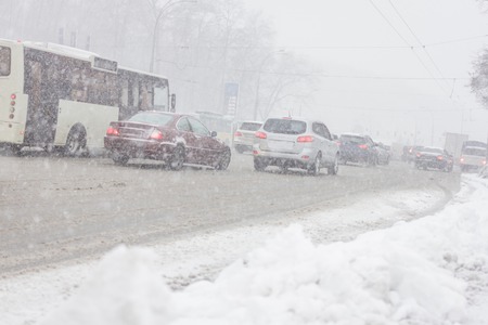 Traffic jam in snowstorm, Kiev. Winter snow road with carsの写真素材