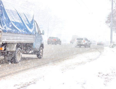 Traffic jam in snowstorm, Kiev. Winter snow road with carsの写真素材