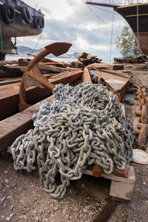 Rusty anchor with chains. Repair boat place outdoor. Bodrum, Turkey.の写真素材
