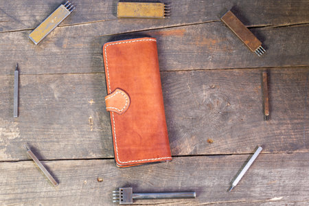 Leather instruments kit. Leather 4 hole puncher. Hobby set of handicraftsman. Passport wallet.の写真素材