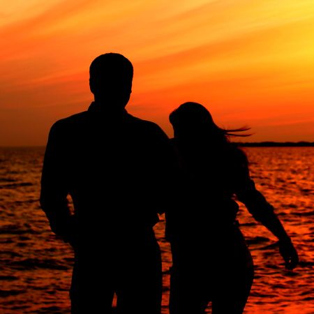 relax on gold sunset  romance flirt of two person on vacationの写真素材