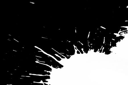 black grunge ink splash on white paperの写真素材