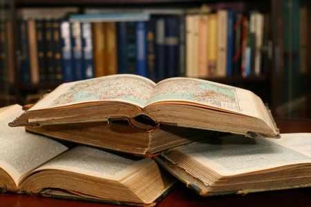 books on table in dark library room