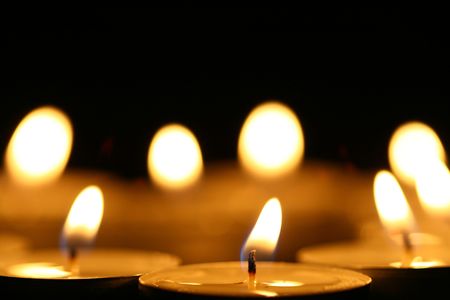 sacred candles in dark on black background