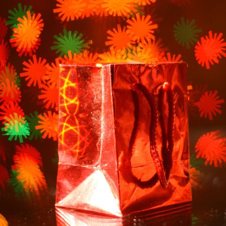 holiday gift bag on background of warm stars 