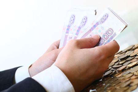 hands hold russian rouble money on white backgroundの写真素材