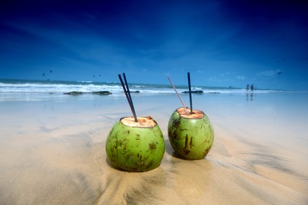 coconut cocktail on beach sandの写真素材