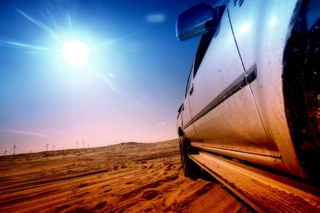 truck in desert sand and blue skyの写真素材