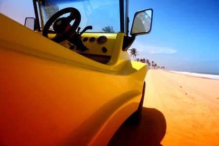 desert buggy in desert sand under blue skyの写真素材