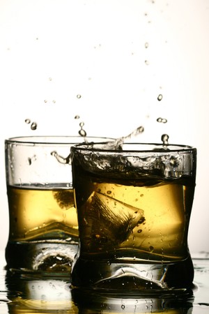 whiskey splash close up in darkの写真素材