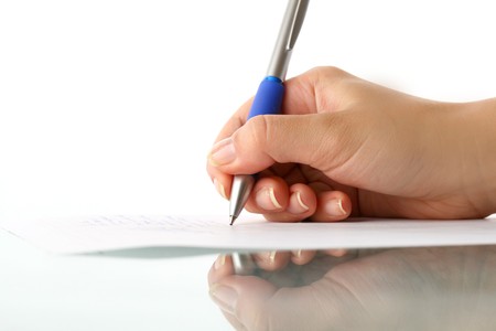 girl write on white paper close up
